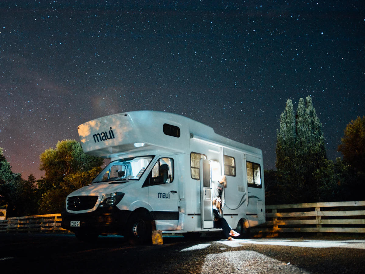 A motorhome parked under a starry night sky