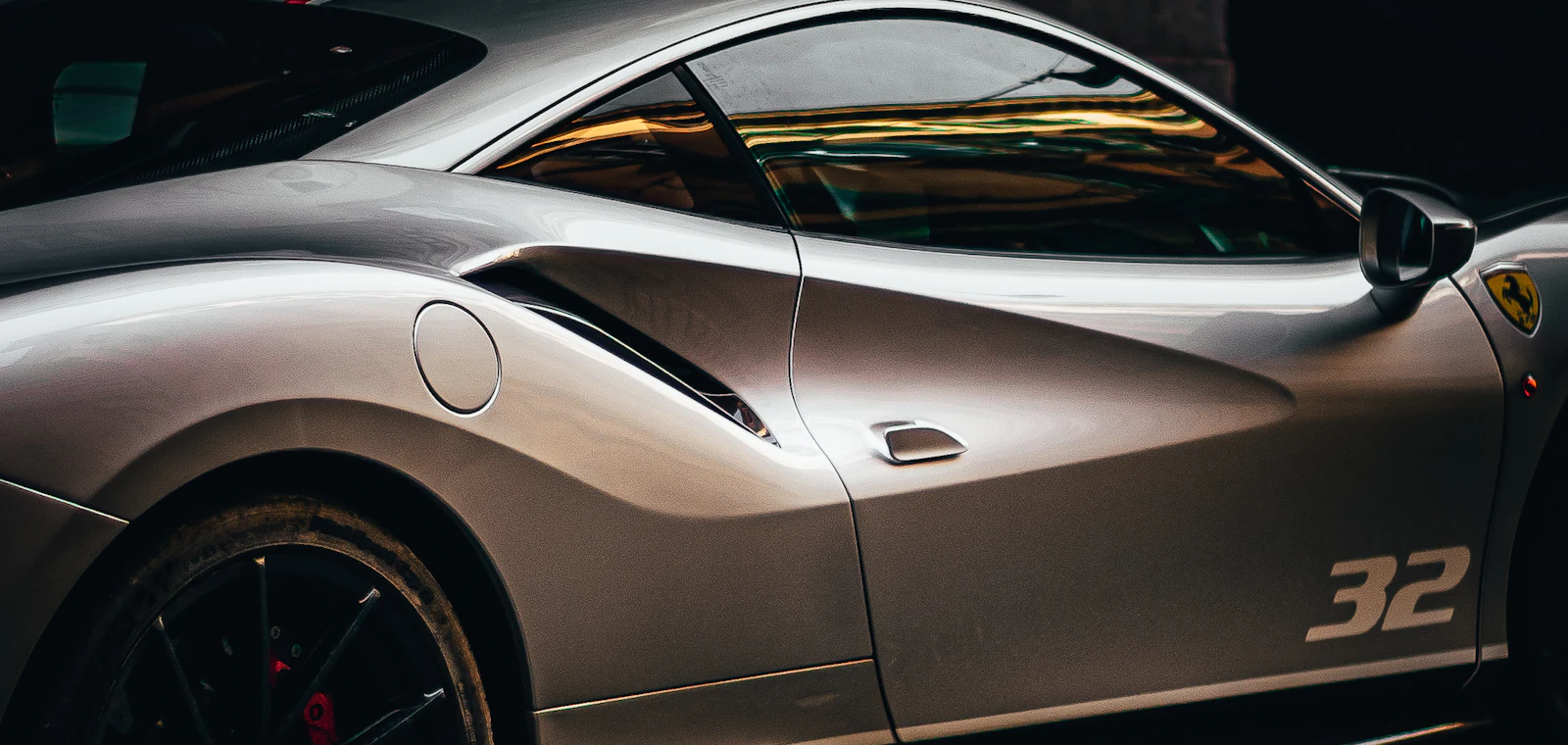 A silver exotic sports car, the kind managed with luxury car rental software