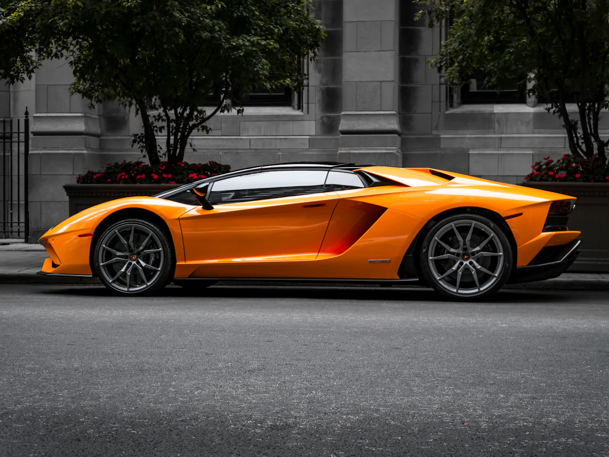 An orange Lamborghini supercar parked on a city street